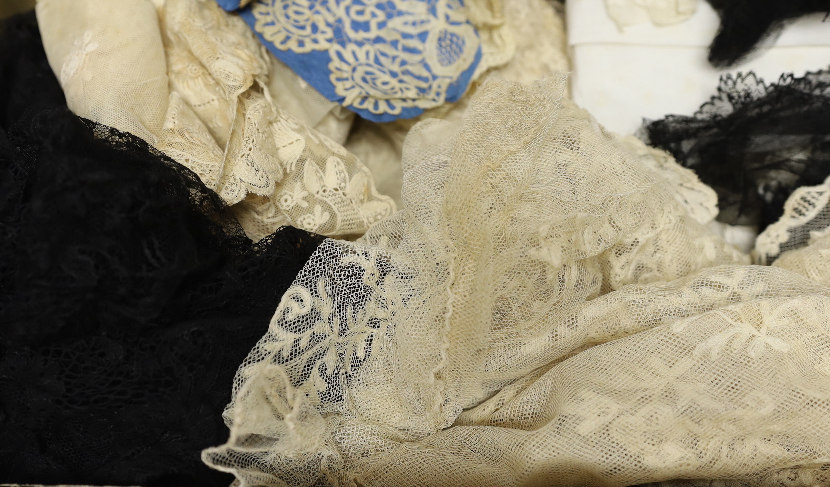 19th century mixed hand made and machine lace: a cream lace needle run bonnet veil, a similar stole and two lengths of wide trimming, together with other lace items and a quantity of black lace